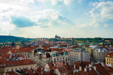 Fototapeta na wymiar Prague rooftops cityscape skyline as seen from Prague's Old Town Hall Tower. St. Vitus cathedral is visible in the far background.