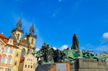 Prague, Czech Republic - CIRCA 2013: Frog eye view of Tyn Church with Jan Hus Memorial in the foreground.