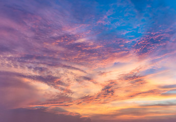 Naklejka na ściany i meble Beautiful cloudy sunset sky with orange, purple, pink, and magenta hue; with vibrant colors. Abstract nature background.