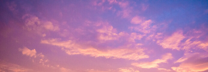 Beautiful cloudy sunset sky with orange, purple, pink, and magenta hue; with vibrant colors....