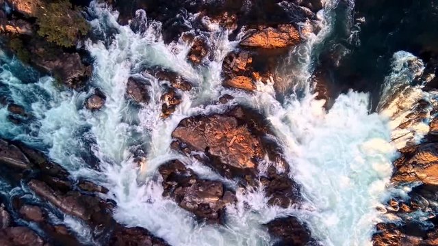 Khone Falls, series of cascading waterfalls and rapids over the Mekong river on Laos and Cambodia border panoramic aerial sunset view. Don Khon island, Four thousand islands area.
