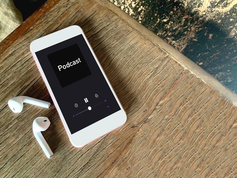 A Mobile Phone Placed On Wooden Table And Playing Podcast  Screen.