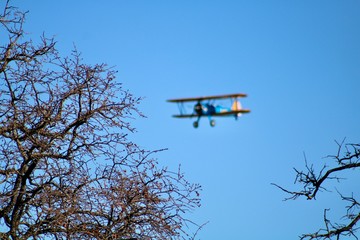Biplane flying over a marina