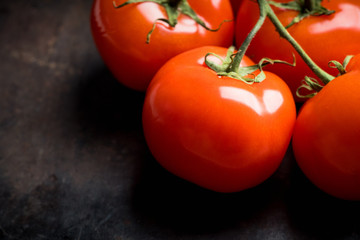 Freshly harvested tomatoes on the rustic background. Selective focus. Shallow depth of field.