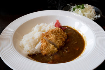 Japanese Curry Rice Deep-fried pork cutlets on a white plate