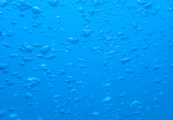 Blurred air bubble in deep blue sea