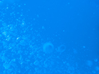Blurred air bubble in deep blue sea