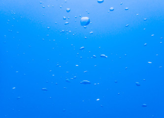 Blurred air bubble in deep blue sea