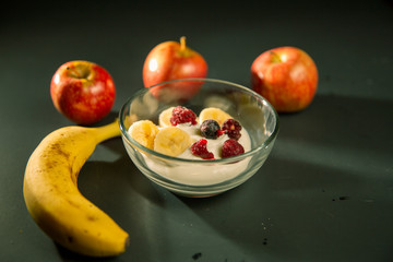 Mature man working at home as a watchmaker and jeweler composing an old clock using a screwdriver and a magnifying glass to be able to see closely