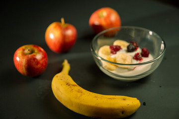 Mature man working at home as a watchmaker and jeweler composing an old clock using a screwdriver and a magnifying glass to be able to see closely