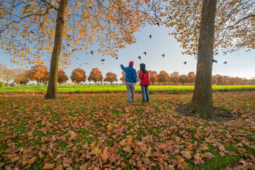 Bird watching people surrounded by autumn colors