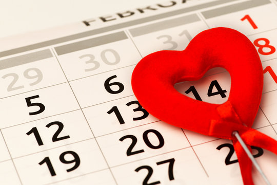 Valentine's day. Close-up of a red heart is on the calendar on the number February 14. Horizontal photo
