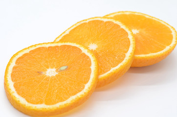 Naklejka na ściany i meble Orange slices on a white background