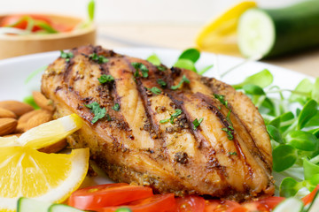 Top view of Fresh salad with chicken breast in white dish on wooden table, Almond,Sunflower seedling,Cucumber,Tomato,Lemon.