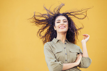Arab woman with curly hair moved by the wind