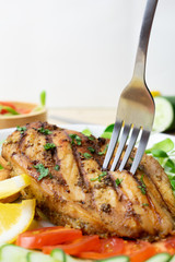 Top view of Fresh salad with chicken breast in white dish on wooden table, Almond,Sunflower seedling,Cucumber,Tomato,Lemon.