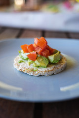 Healthy rice cracker snack with fresh avocado and tomato