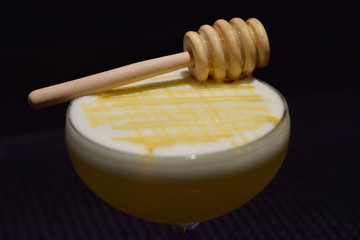 Fototapeta na wymiar Cocktail with honey comb close up