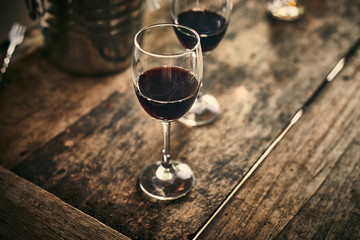 Red wine on wood background..