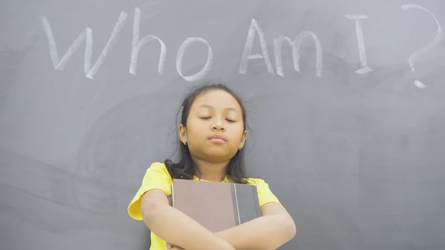 Female student standing with text of who am i?