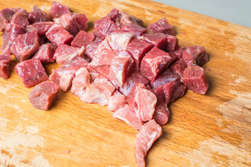 Small sliced red calf tenderloin on cutting board.