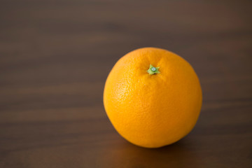 orange on wooden dining table