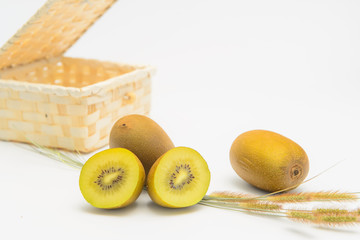 The still life of several golden kiwifruit is set on the white background