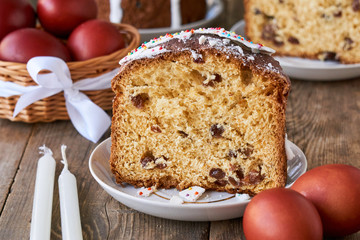 Piece of easter cake with brown colored eggs on a wooden table 