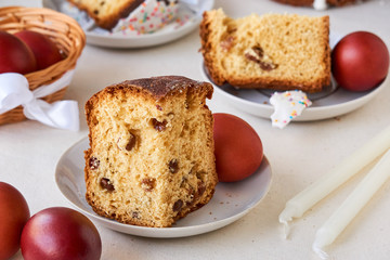 Piece of easter cake with brown colored eggs on a light background