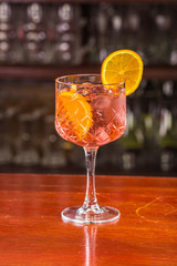 Aperol coctail on a wooden stand. 