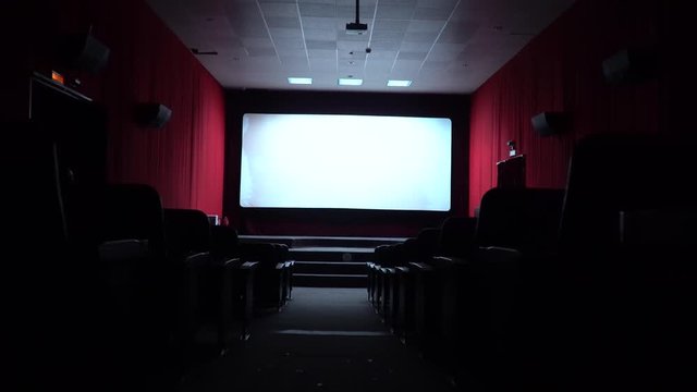 Empty movie theater, watching a movie. cinema hall. Viewers watch a movie in a movie theater. Filmmakers watch the film on an empty screen