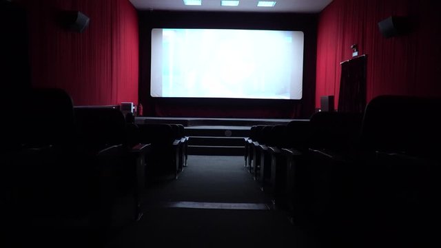 Empty movie theater, watching a movie. cinema hall. Viewers watch a movie in a movie theater. Filmmakers watch the film on an empty screen