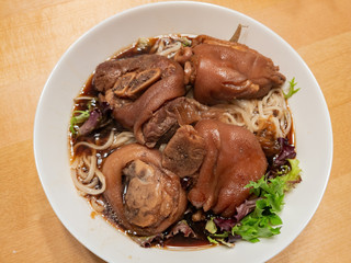 Close up shot of a bowl of braised pork feet noodle