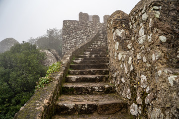 Steps leading up to the highest point at the ruins of the Moorish Castle, in the fog - obrazy, fototapety, plakaty