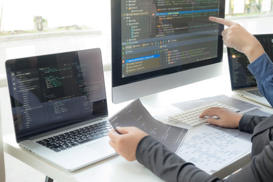 Programmers work on the development of coding and coding technology on white desks and website design, software, data processing companies, servers.