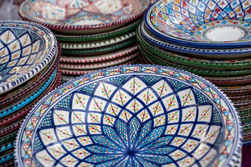 Decorated ceramic bowls and plates on display at the Surajkund Crafts Mela in Faridabad India - selective focus