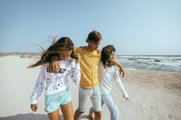 Group of happy teenage friends on the beach
