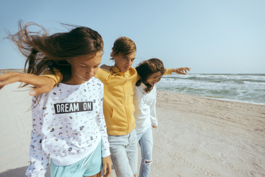 Group of happy teenage friends on the beach