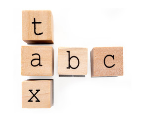 Tax ABC. Concept for taxes. Woodblock letter words are arranged in crossword style. Lowercase black letters in typewriter font. Isolated on white.