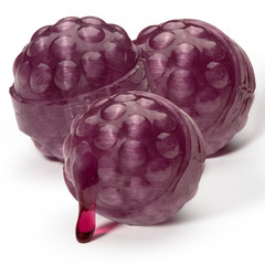 Three caramel balls like raspberries of violet color