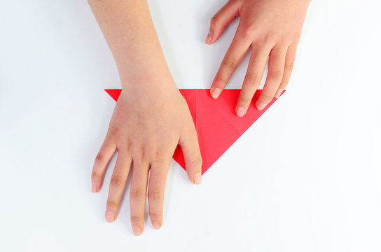 Fold triangular red paper on a white background