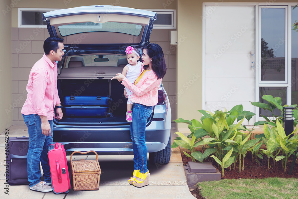 Poster asian family preparing suitcase to the car