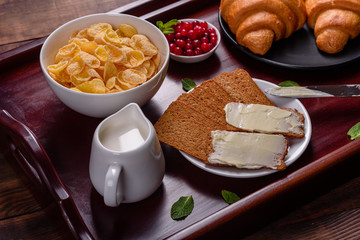 Delicious breakfast with fresh croissants and ripe berries