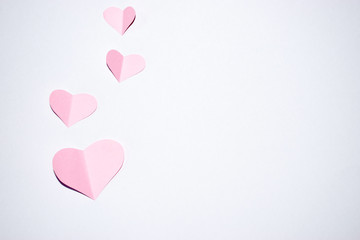 Valentines day background.Pink paper hearts with white background.