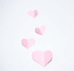 Valentines day background.Pink paper hearts with white background.
