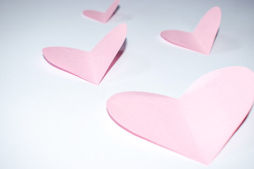 Valentines day background.Pink paper hearts with white background.
