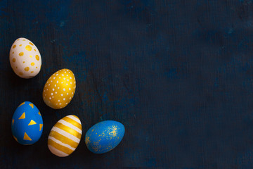 Easter decoration eggs with golden Eggs on Dark Background