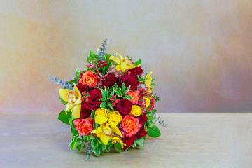 wedding bouquet of scarlet roses with green leaves,