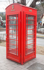 Fototapeta na wymiar red telephone booth or cabin in Sinaia, Romania