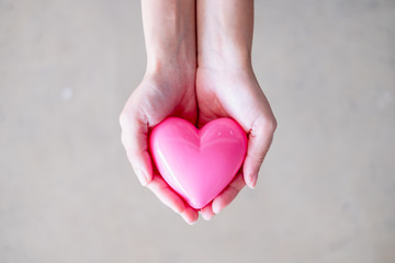 Fototapeta premium Female hand holding heart, concept of health , medicine and charity